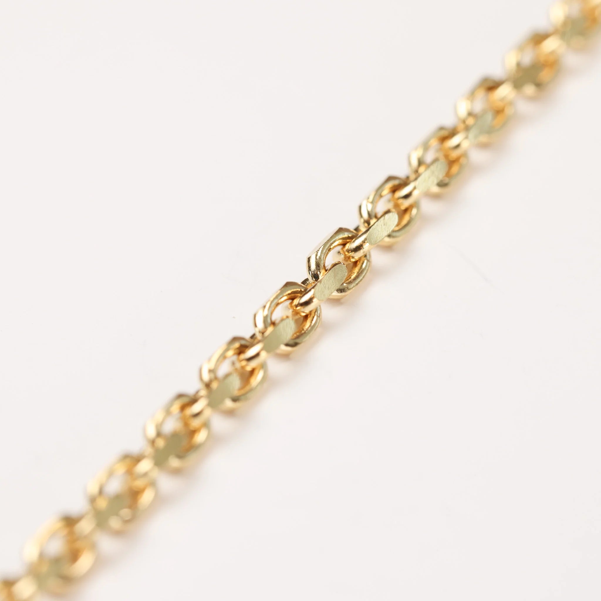 A gold Bracelet on a White Background