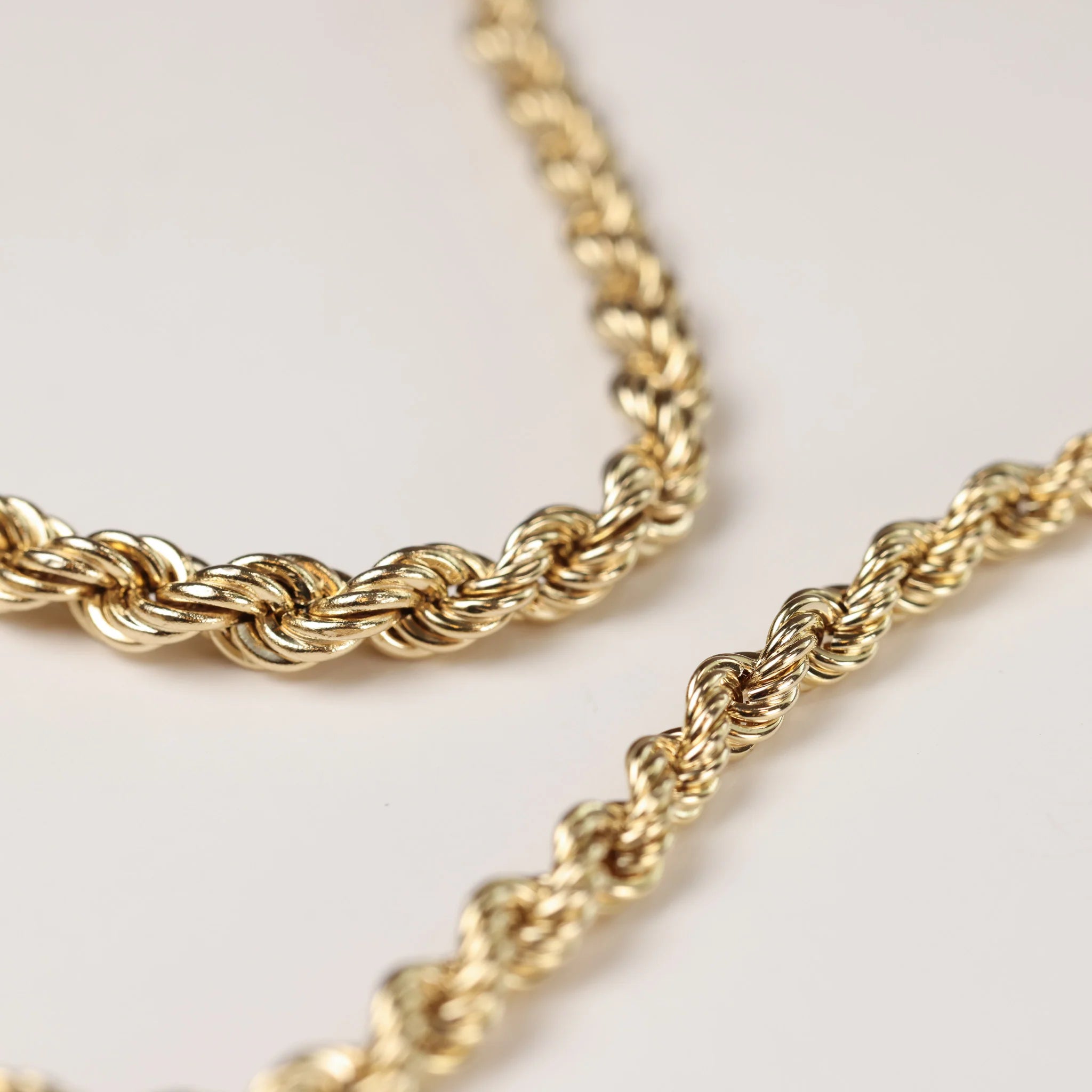 A gold chain on a white background