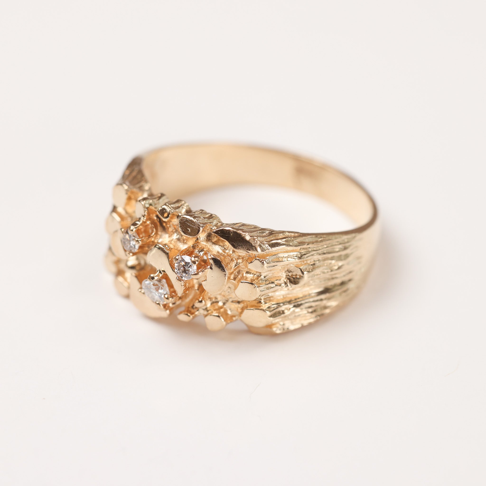 A unique gold ring on a white background