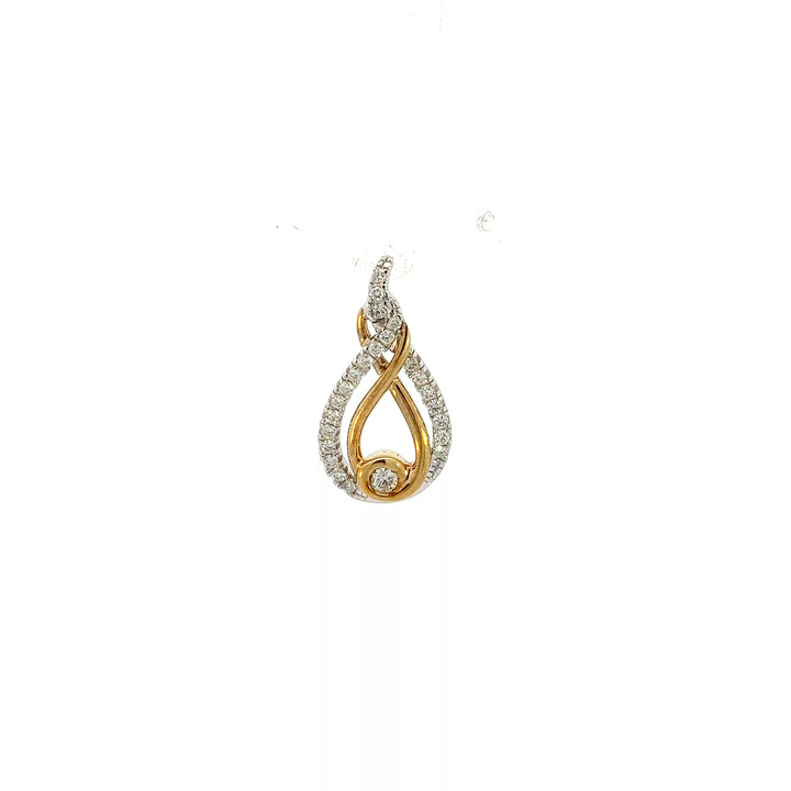 A gold and diamond pendant with a tear shaped design.