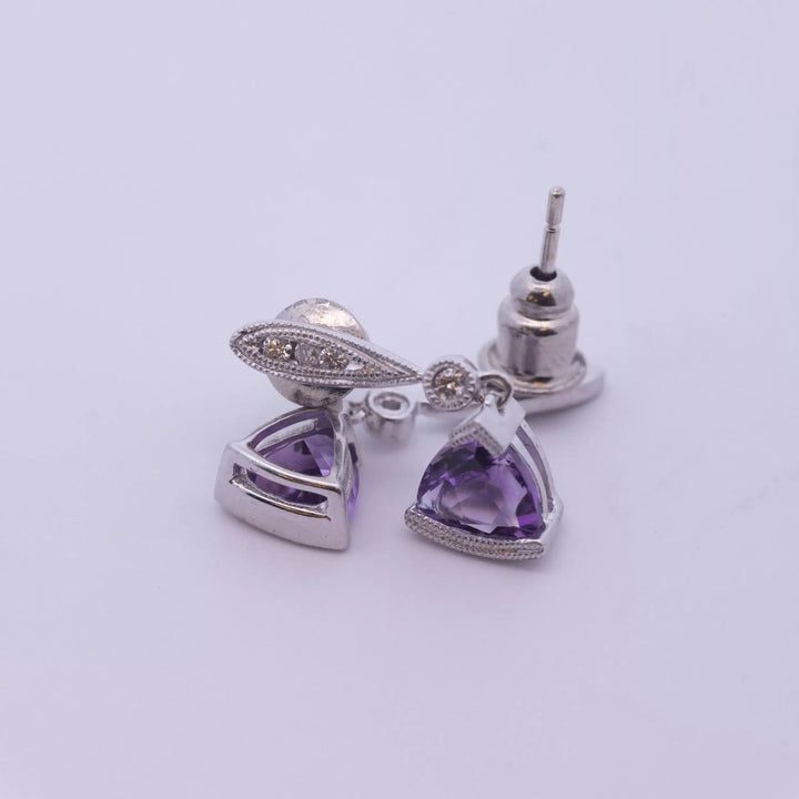 Amethyst and diamond stud earrings made of 14 Karat White Gold.