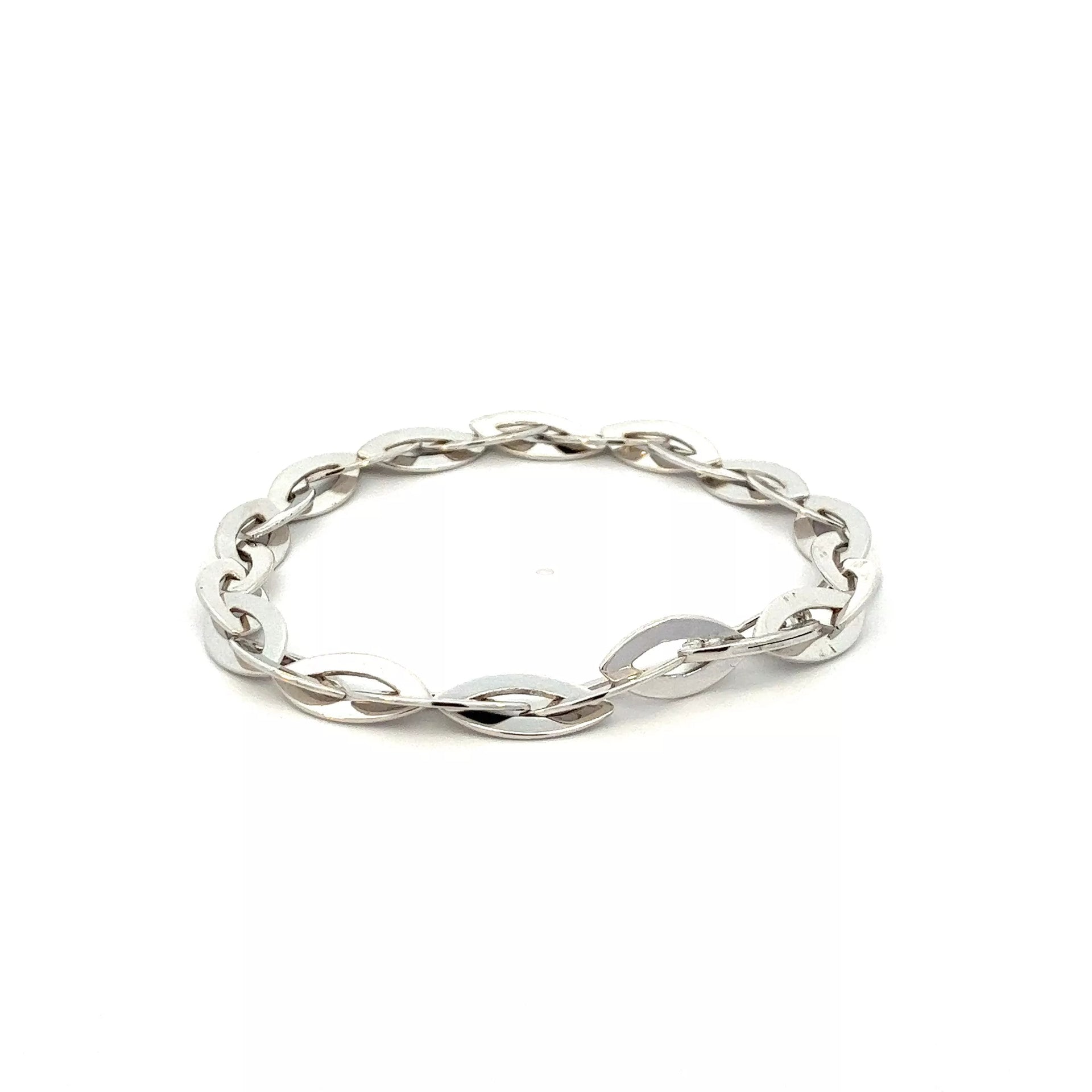 A silver bracelet with an oval link on a white background.