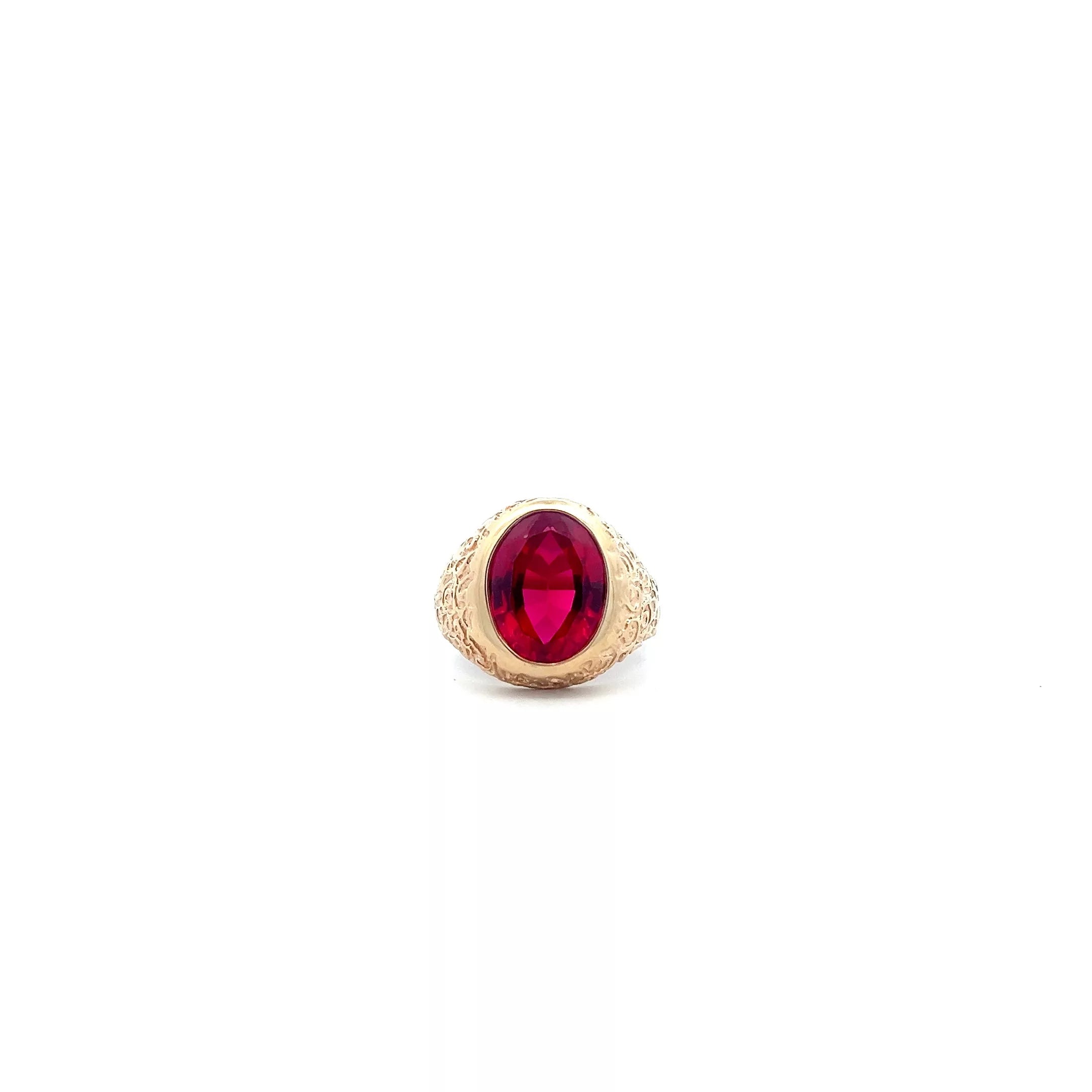 A gold ring with a ruby stone.