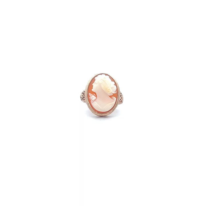 A rose gold ring with a white stone.