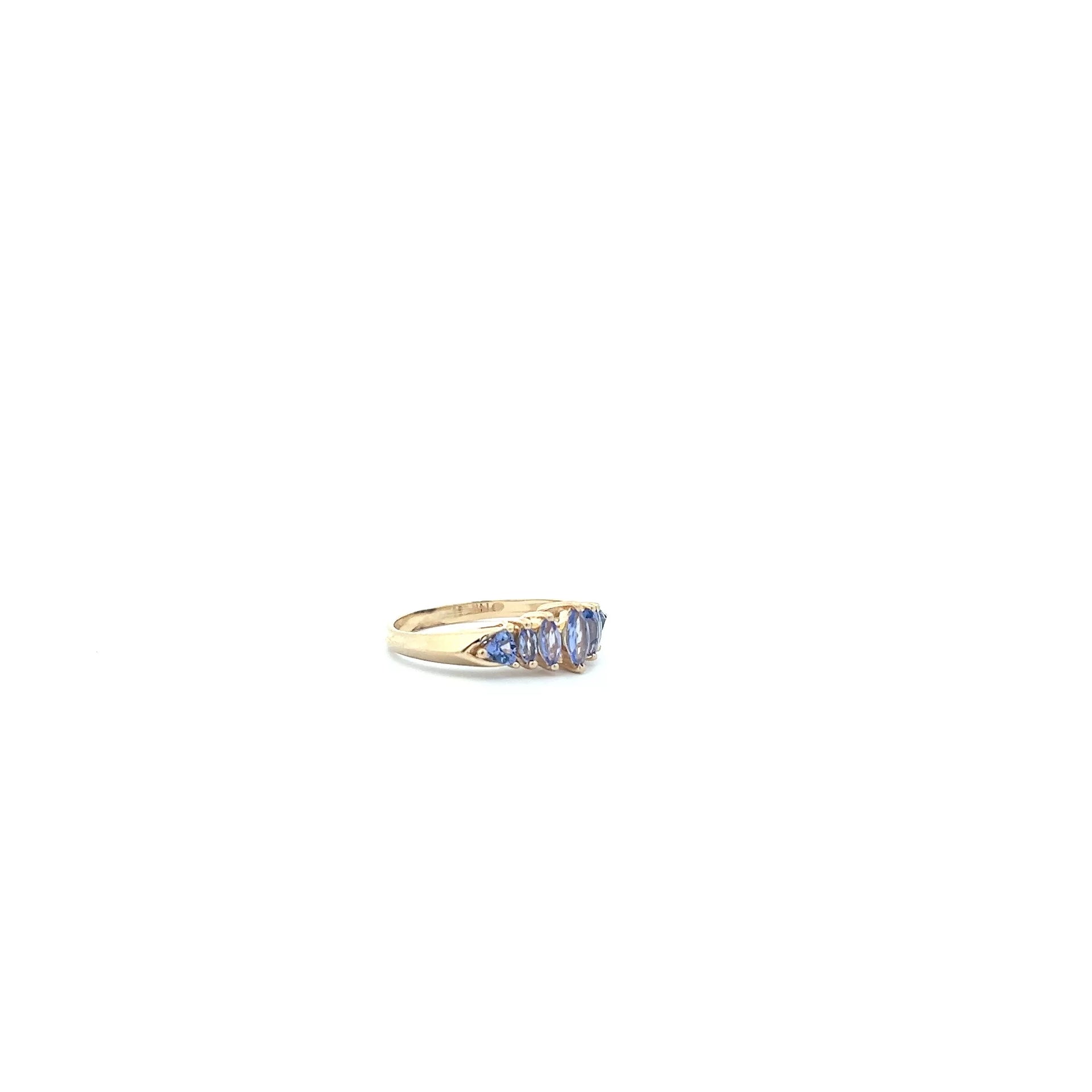 A yellow gold ring with blue sapphires.