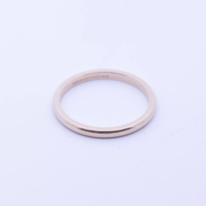 A 14 Karat Yellow Gold Band on a white background.