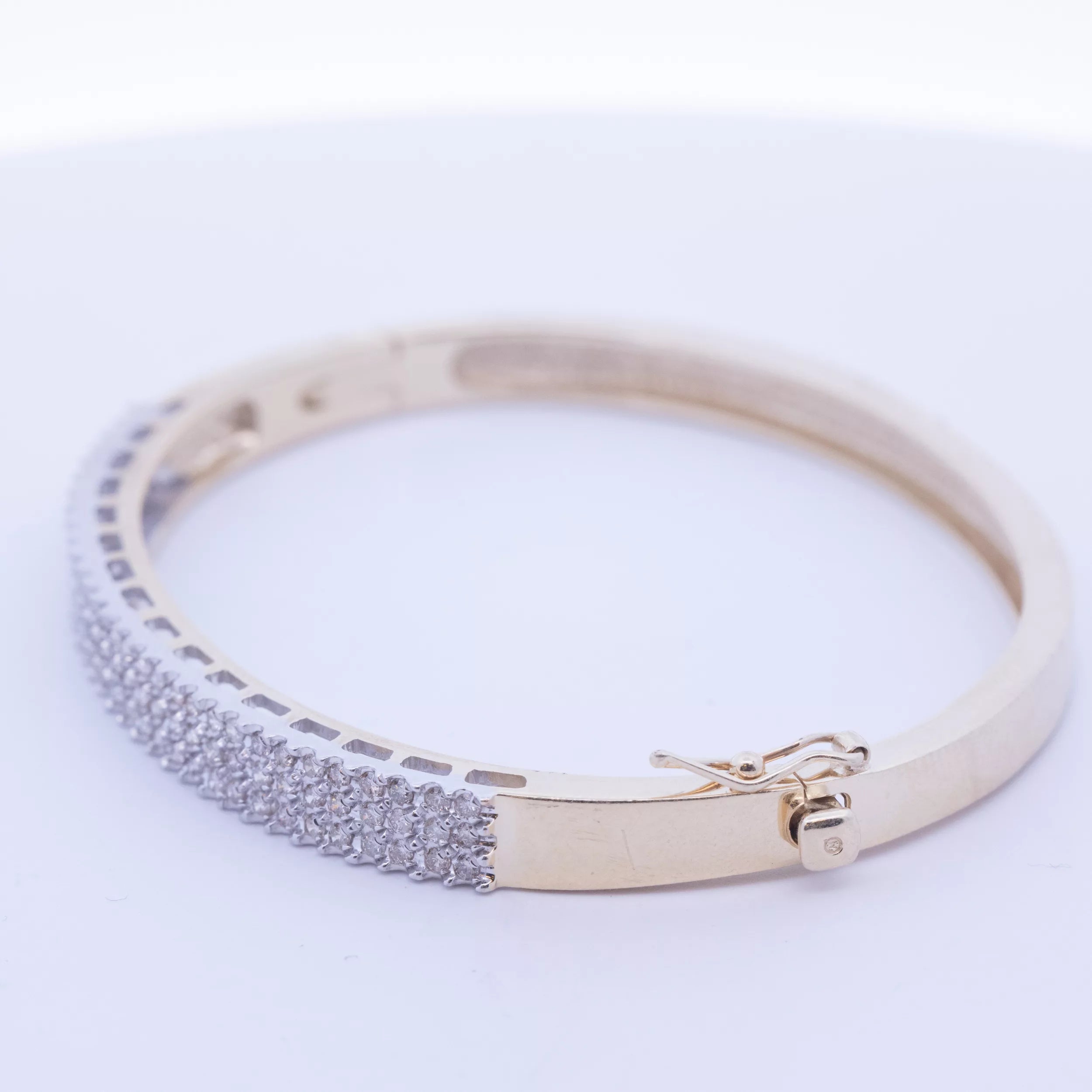 A 14 karat yellow gold white stone tennis bracelet, crafted from 14 karat yellow gold.