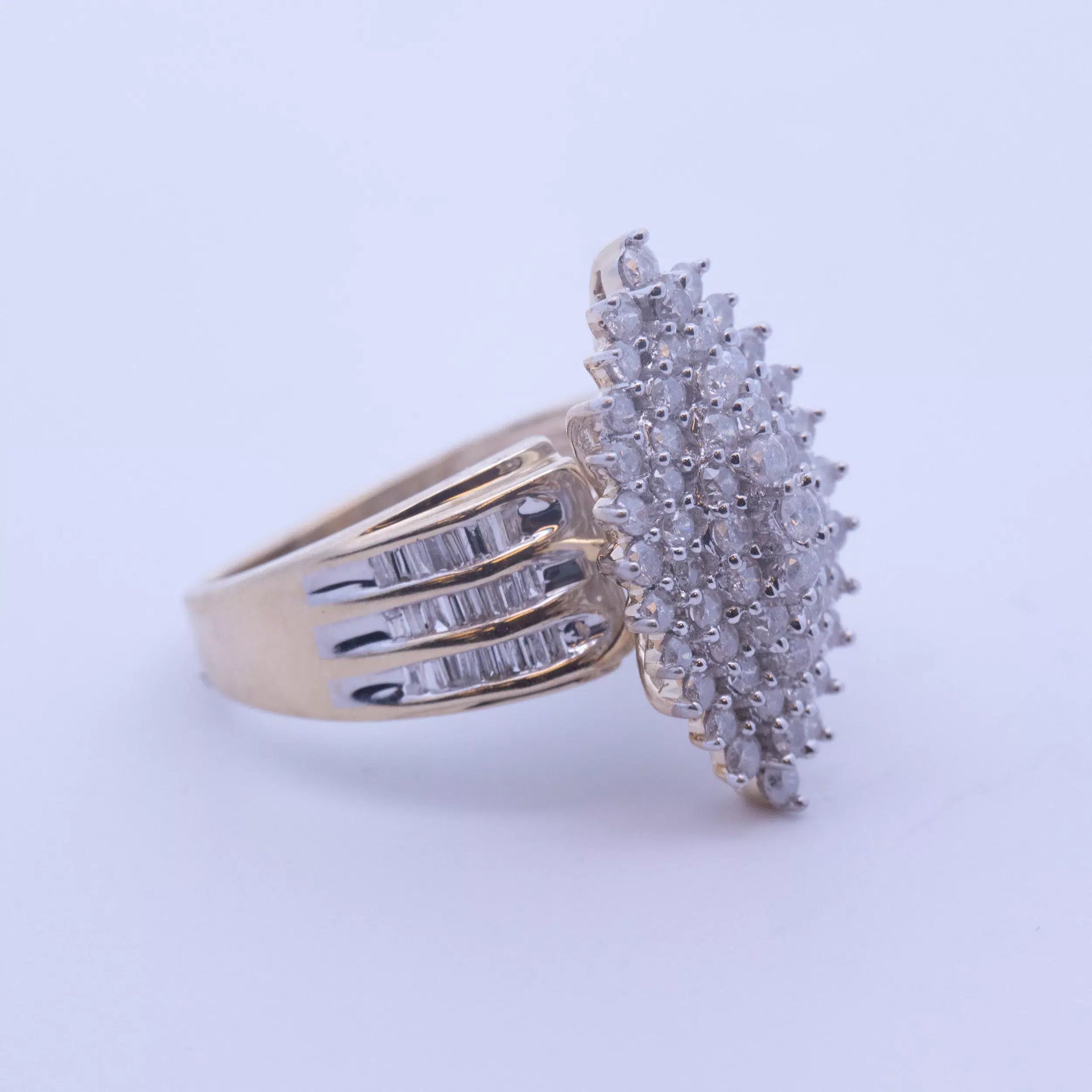 A yellow gold ring with a cluster of diamonds, made from 14 Karat Yellow Gold White Stone Tennis Bracelet.