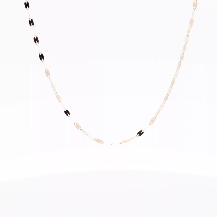 A 14 Karat Yellow Gold Fashion Chain necklace with a black and gold chain.