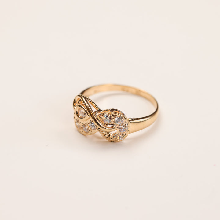 14 Karat Yellow Gold Tanzanite Diamond Ring - Size 5 with an infinity symbol centerpiece adorned with small white gemstones, crafted from 14 karat yellow gold. This enchanting ring is displayed against a plain light background.