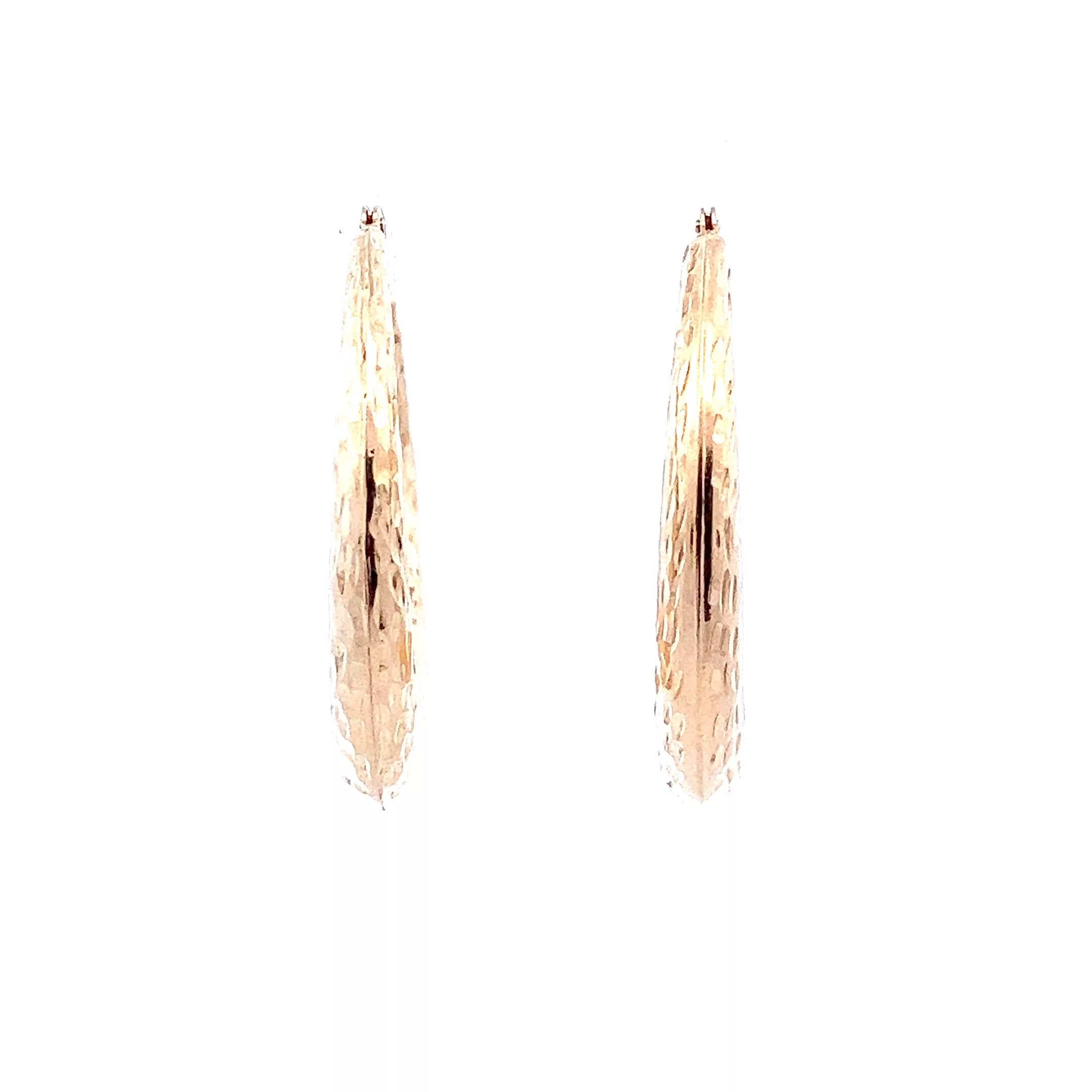 A pair of gold hoop earrings on a white background.