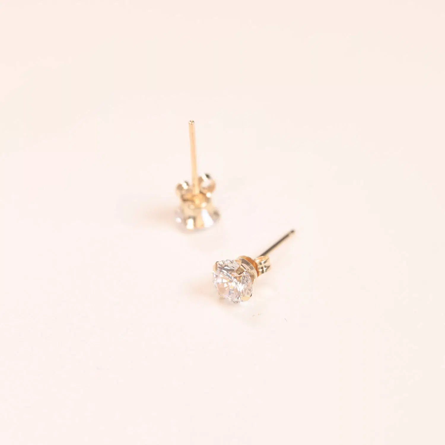 A pair of 14 Karat Yellow Gold Comfort Fit Band earrings with diamonds.