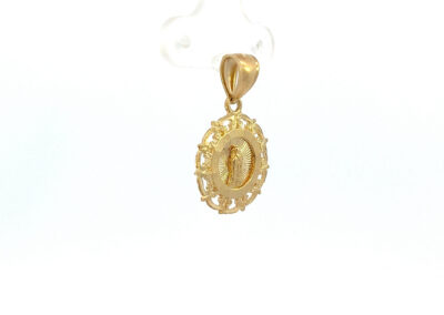 A gold plated pendant with an ornate design.