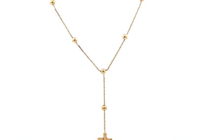A gold plated necklace with a cross on it.