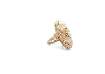 A gold ring with pink and white stones.