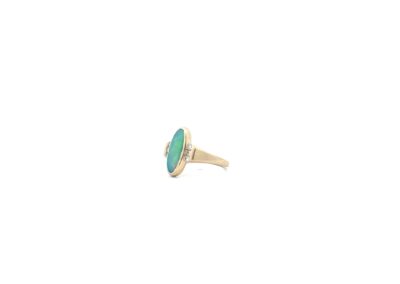 An oval turquoise stone ring on a white background.