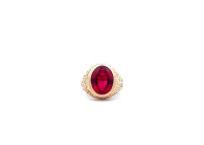 A gold ring with a ruby stone.