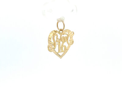 A gold heart shaped pendant hanging from a chain.