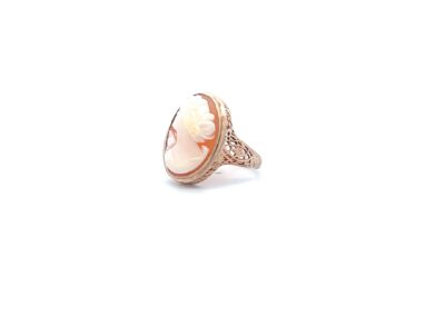A rose gold ring with an oval shaped amethyst stone.