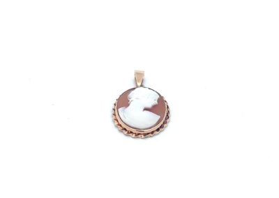 A white and brown cameo pendant on a white background.