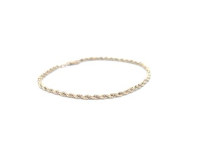 A gold rope bracelet on a white background.