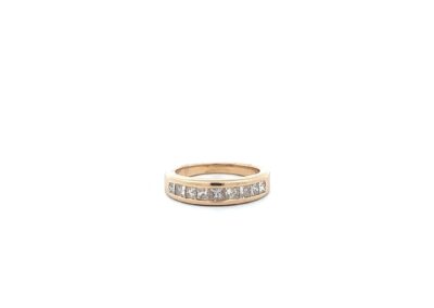 A yellow gold ring with a row of diamonds.