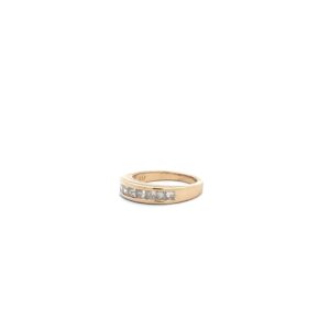 A yellow gold ring with a row of diamonds.