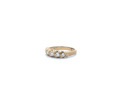 A gold ring with three diamonds.