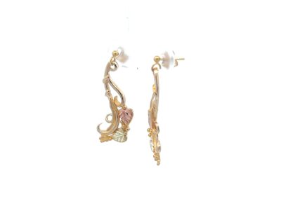 A pair of gold - plated earrings with a flower on them.