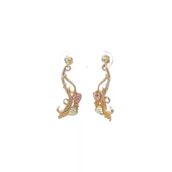 A pair of gold - plated earrings with pink crystals.