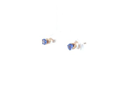 A pair of blue sapphire stud earrings on a white background.