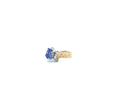 A gold ring with a blue sapphire stone.
