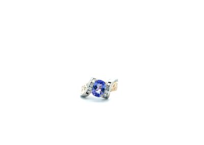 A tanzanite and diamond ring on a white background.