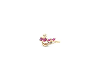 A gold ring with a pink stone in the middle.