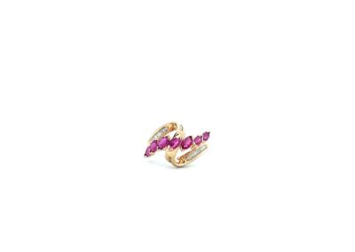 A gold ring with a pink stone in the middle.