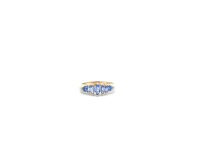 A tanzanite and diamond ring on a white background.