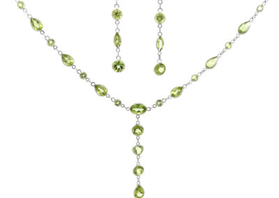A peridot necklace and earring set with the 14 Karat Yellow Gold Cross Pendant.