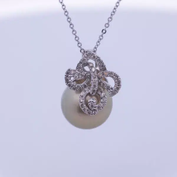 A 14 Karat White Gold Pearl Diamond Necklace on a white background.