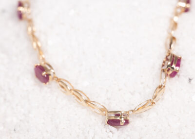 A 14 Karat Yellow Gold Ruby Bracelet with ruby stones.