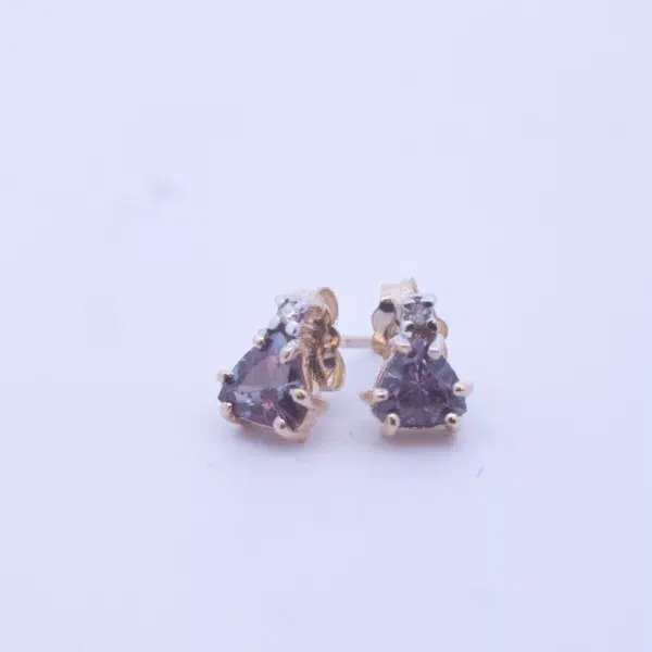 A pair of 14 Karat Yellow Gold Tanzanite Clear Stone stud earrings.