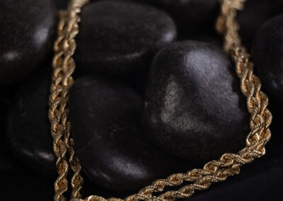 A 14 Karat Yellow Gold Rope Chain on a black background.
