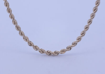 A 14 Karat Yellow Gold Rope Chain on a white background.