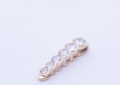 A 14 Karat Yellow Gold White Stone Tennis Bracelet with a row of diamonds.