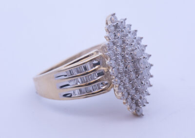 A yellow gold ring with a cluster of diamonds, made from 14 Karat Yellow Gold White Stone Tennis Bracelet.