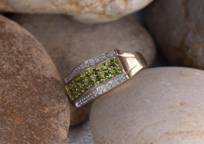 A 14 Karat Yellow Gold White Stone Tennis Bracelet with green peridots, diamonds.