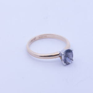 A 14 Karat Yellow Gold White Stone Tennis Bracelet with a blue sapphire stone.