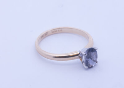 A 14 Karat Yellow Gold White Stone Tennis Bracelet with a blue sapphire stone.
