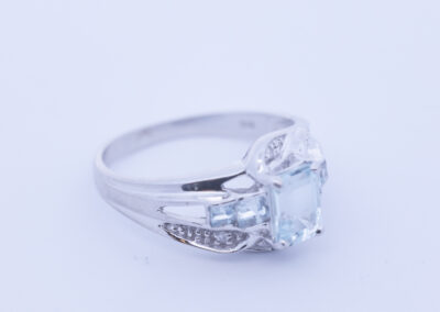 Aquamarine and diamond ring featuring a 14 Karat Yellow Gold White Stone Tennis Bracelet band.