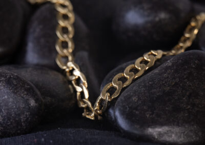 A 14 Karat Yellow Gold White Stone Tennis Bracelet on a black background.