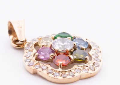 A fashion-forward multi colored stone pendant featuring diamonds on a 14 Karat Yellow Gold Fashion Chain.
